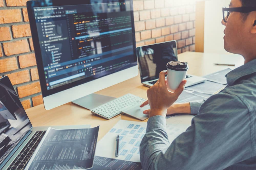A designer sketching out a user interface on a whiteboard